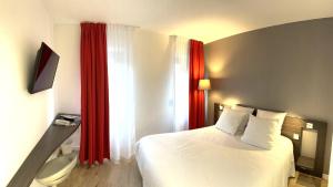 a bedroom with a white bed and red curtains at Hôtel Le Cousture in Toulouse +17 photos