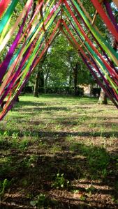 Une bande de streamers colorés suspendus à une structure dans un parc dans l'établissement Polani - Il Noceto, à Cave