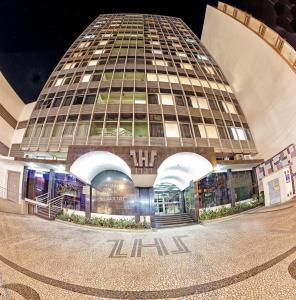 a large building in front of a building at Hotel San Silvestre in Tubarão