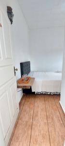 a bedroom with a bed and a wooden table at Suítes da Praça Tiradentes in Tiradentes +27 photos