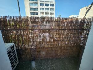 a wooden fence in front of a tall building at Luxury Apartment Acropolis Syggrou in Athens