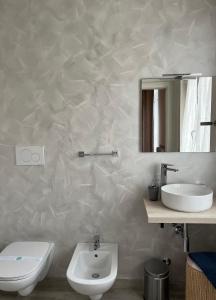 a bathroom with a sink and a toilet and a mirror at B&B Panorama Iseo in Iseo