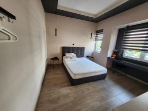 a bedroom with a bed in the middle of it at Luxury Apartment Acropolis Syggrou in Athens