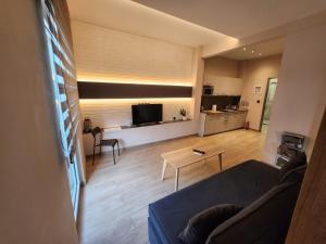 a living room with a couch and a table at Luxury Apartment Acropolis Syggrou in Athens