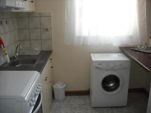 a small kitchen with a washing machine and a sink at Kostas--Sarantis--2 in Lakíthra