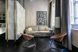 a living room with a couch and two chairs at Numa Florence Palazzo Moro in Florence