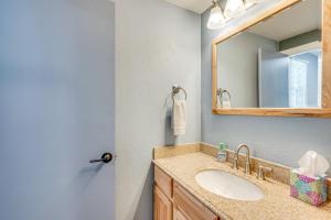 a bathroom with a sink and a mirror at Cozy Estes Park Condo with Balcony and Fireplace! in Estes Park