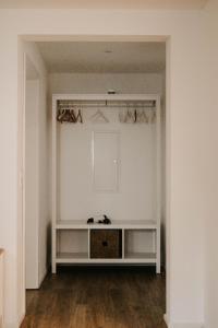 an empty room with white walls and wood floors at Ferienwohnung Ziegler in Ebersburg