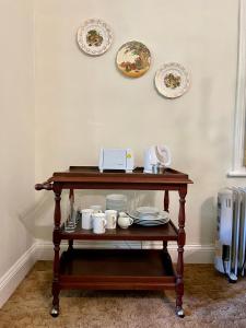 a table with plates and mugs on top of it at Heritage Haven in Howick