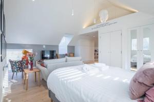 a bedroom with a large bed and a living room at Luxury City Centre Flat with Stunning Water View in Cambridge