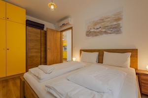 Säng eller sängar i ett rum på Casa Mimoza Apartman By BLTN Balatonföldvár