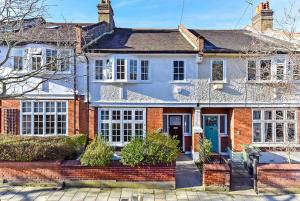 a large brick house with a blue door at Beautiful Family Victorian Home in Crystal Palace
