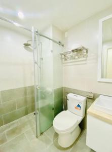 a bathroom with a toilet and a glass shower at Scenic Valley With Free BreakFast, Free Massage, More Discount Supermarket in Ho Chi Minh City