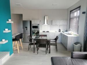 a kitchen with a table and chairs in a room at Enjoy Paradise Newave Holiday - Appartment No 8 in Flic-en-Flac