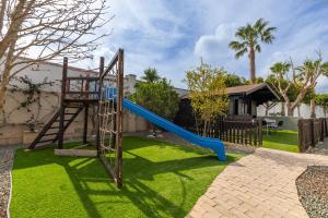 a playground with a slide in a yard at WaterWheel Villa by Fidalsa in Almoradí