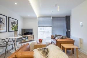 a living room with a couch and a table at Luxury City Centre Apartment in Cambridge
