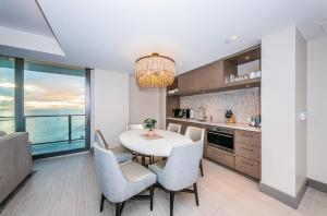 a kitchen and dining room with a table and chairs at 1612 - Beachfront Condo in Clearwater Beach