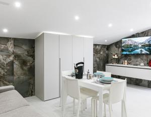 a white dining room with a white table and chairs at RESIDENCE MARCO POLO in Montesilvano