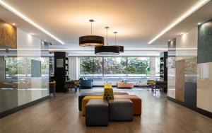 a lobby with a couch and chairs in a building at Gran Versalles in Madrid