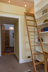 a stairwell in a home with a book shelf at Unique Edinburgh New Town Apartment near Princes Street in Edinburgh