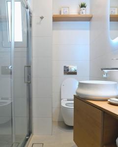 a bathroom with a toilet and a sink and a shower at OpenSea in Chalkida