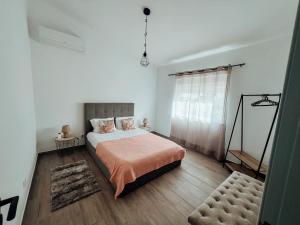 a bedroom with a large bed and a window at Casa Dom Simões in Aljezur