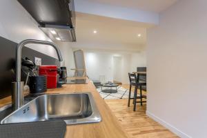 a kitchen with a sink and a counter top at Saint-Just in Lyon