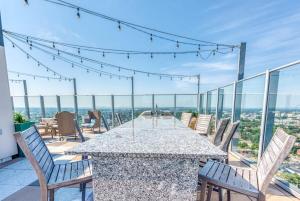 a table and chairs on a balcony with a view at CozySuites 800 Tower 1BR w sky pool, gym! 20 in Louisville