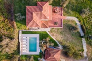 an overhead view of a house with a swimming pool at Nature Retreat Skiathos Villa in Kolios