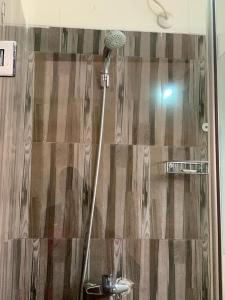 a shower in a bathroom with a shower curtain at FOSTER INN (ASAKE) in Ibadan