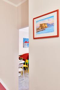 a view of a living room with a painting on the wall at Pupatella Apartments in Naples