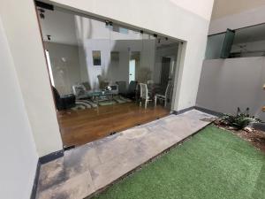 a living room with a large sliding glass door at Espacio Luxury Apartments- Edificio Alcanfores in Lima