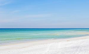 a group of people on a beach with the ocean at Tidewater 2308 by Emerald Coast Retreats in Panama City Beach