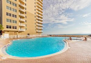 a swimming pool in front of a building at Tidewater 2308 by Emerald Coast Retreats in Panama City Beach