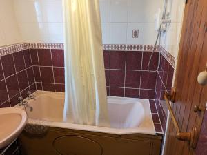 a bathroom with a tub and a sink at Rosecare Barn in Bude +15 photos