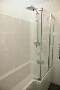 a shower with a glass door in a bathroom at Pheasants Roost at Tove Valley Cottages in Towcester