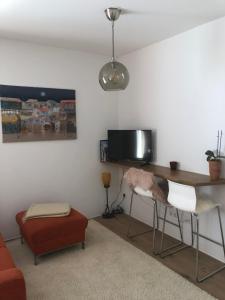een woonkamer met een bureau en een televisie bij Apartment Vroni in Salzburg