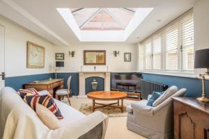 a living room with a skylight and a living room with a fireplace at Stunning 3 Bedroom Home with Terrace & Parking in Trumpington