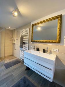 a bathroom with a white sink and a mirror at Haus Silberberg in Haslach im Kinzigtal