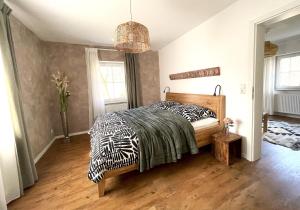 a bedroom with a bed with a zebra blanket at Haus Silberberg in Haslach im Kinzigtal