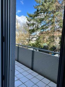 a view from a window of a balcony with a tree at AMAROOM apartments 2 in Karlsruhe