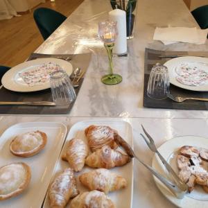 a table with a tray of pastries and plates of food at B&B IL GLICINE in Pellezzano