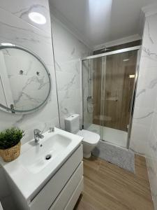 a bathroom with a sink and a toilet and a mirror at VILLA MOLEIRO RAMBLA in Santa Cruz de Tenerife +23 photos