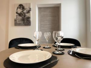 una mesa con platos y copas de vino. en OPP Peterborough - High end 2 bed 2 with secure parking! BIG SAVINGS booking 4 nights or more!, en Peterborough