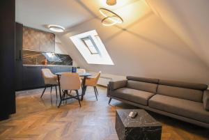 a living room with a couch and a table at 20% Discount! 2 Bedroom Apartment Vitosha View in Sofia