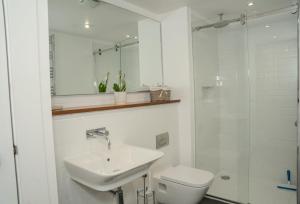 a bathroom with a sink and a toilet and a shower at The Kinross Residence in Kinross