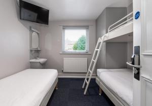 a bunk bed room with two beds and a ladder at Stableside Hostel at York Racecourse in York +81 photos