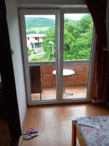 a room with a sliding glass door with a view of a patio at HOTEL WIEN in Barakovići