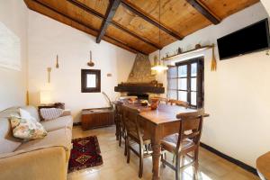 a living room with a wooden table and a couch at La Dimora del Tempo Perduto in Castelvecchio di Rocca Barbena