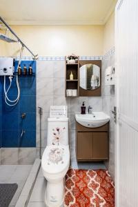 a bathroom with a toilet and a sink at Lovely Nest Townhouse in Clark